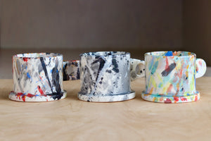 A selection of EXP standard splatter mugs by Peter Shire and Echo Park Pottery.