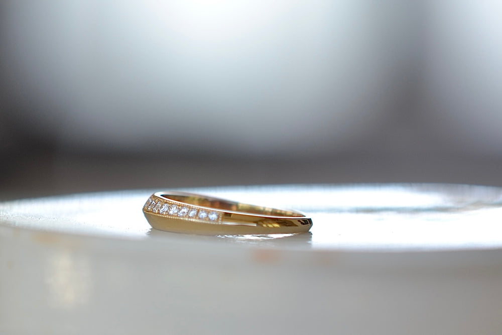 Side view of Petite Crescent Ring with Switch Pavé in 18k yellow gold designed by Lizzie Mandler. 