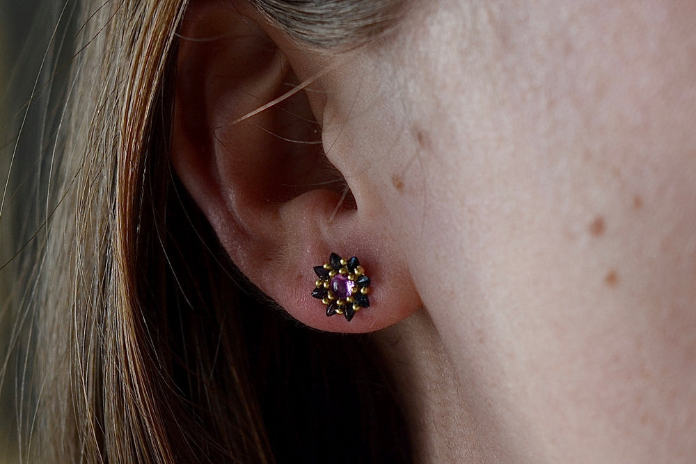 Wearing the pink and teal Daisy stud earring by Polly Wales.
