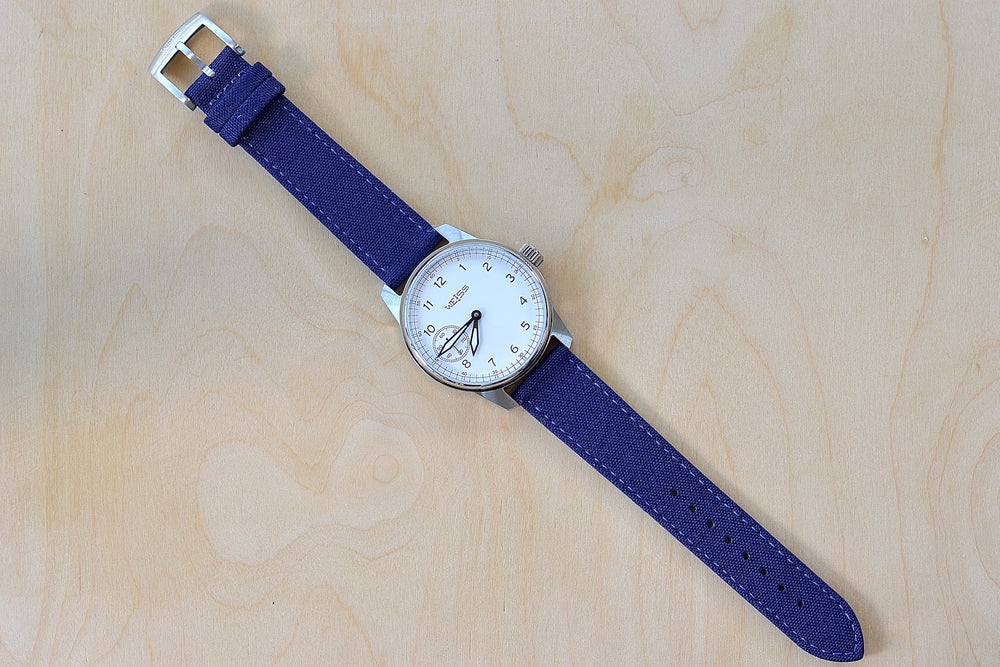 Full view of Weiss Watch 42mm Standard Issue Field Watch with White Dial and blue canvas strap is manually wound, made with American parts, featuring Super Luminova hands and markers.