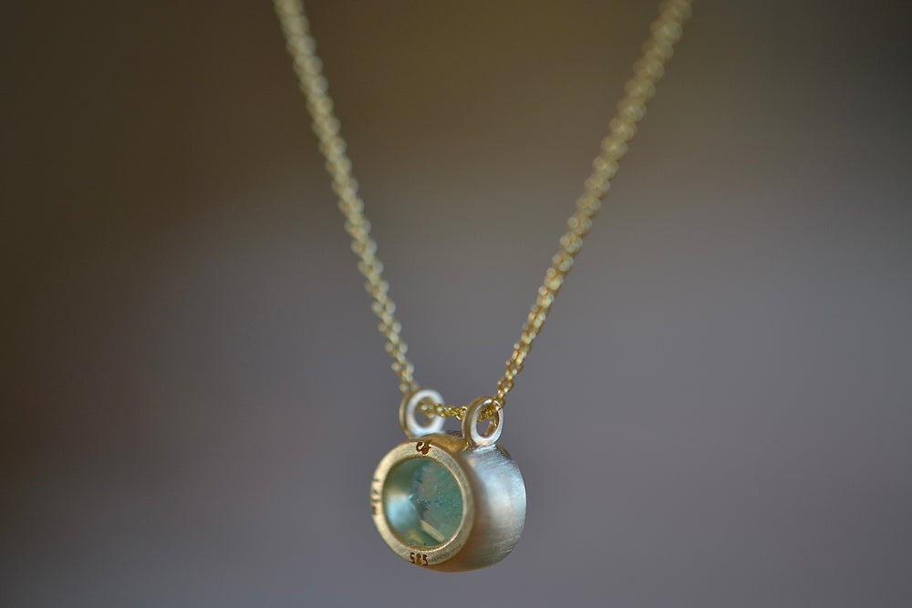 Side view of the Duo Bale Oval Emerald Necklace by Elizabeth Street Jewelry.