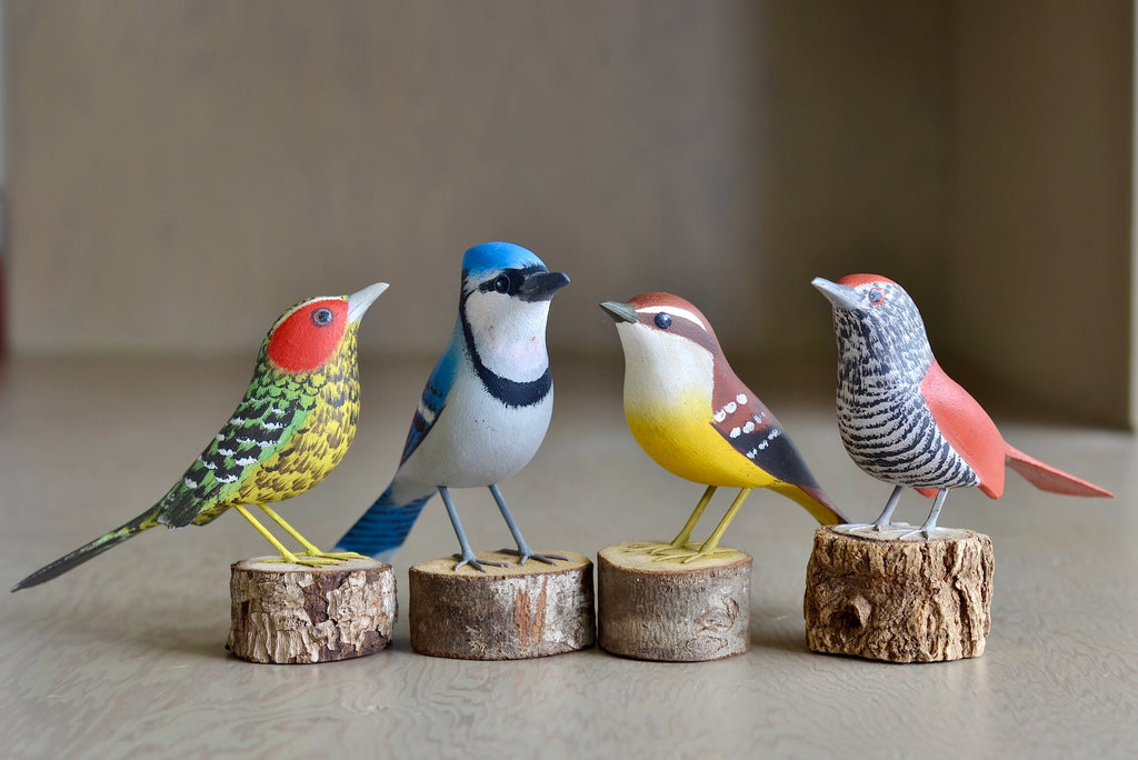 Selection of wooden and hand carved birds from Brazil, showing Red Spotted Woodpecker, Blue Jay, Andtwern and Striped Choca.