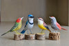 Selection of wooden and hand carved birds from Brazil, showing Red Spotted Woodpecker, Blue Jay, Andtwern and Striped Choca.