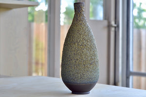 Heather Rosenman Tall Green Vase in Volcanic glaze. in different light.