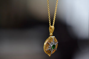 Side view of Star locket with Green Emerald and diamonds.