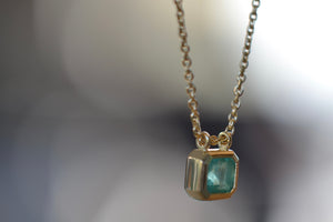 Side view of the Duo Bale Emerald Necklace by Elizabeth Street Jewelry.