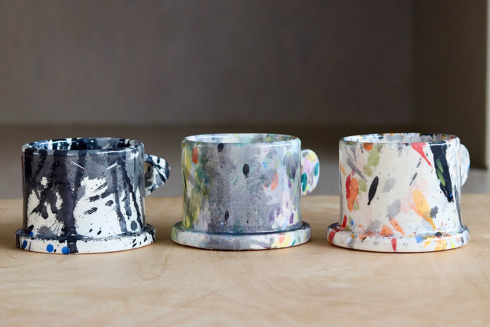 A selection of EXP standard splatter mugs by Peter Shire and Echo Park Pottery.
