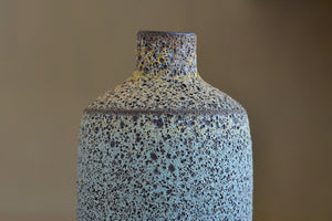 Detail of Heather Rosenman volcanic vase in ble and gray.