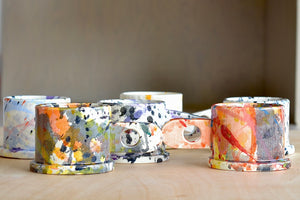 A selection of EXP standard splatter mugs by Peter Shire and Echo Park Pottery. The EXP standard splatter mug is a glazed ceramic mug with a triangular handle, made by utilizing slab construction that is hand rolled. Inspired by the techniques of Adrian Saxe and the paintings of Sam Francis, the mug was designed by Peter Shire for Echo Park Pottery. Peter is one of the original members of the Memphis Group, founded by Ettore Sottsas in Italy. Handmade in Echo Park, Los Angeles.