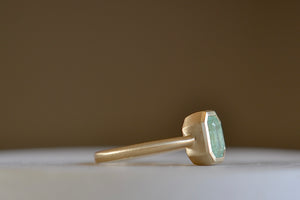 Side view of the simple Emerald Rectangular ring by Elizabeth Street made with a pale Columbian emerald.
