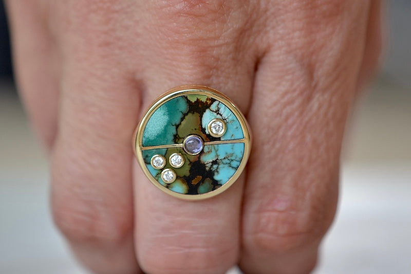 Wearing the Retrouvai Turquoise Compass Signet ring with Diamonds and tanzanite accent stone in 14k yellow gold and inlay.