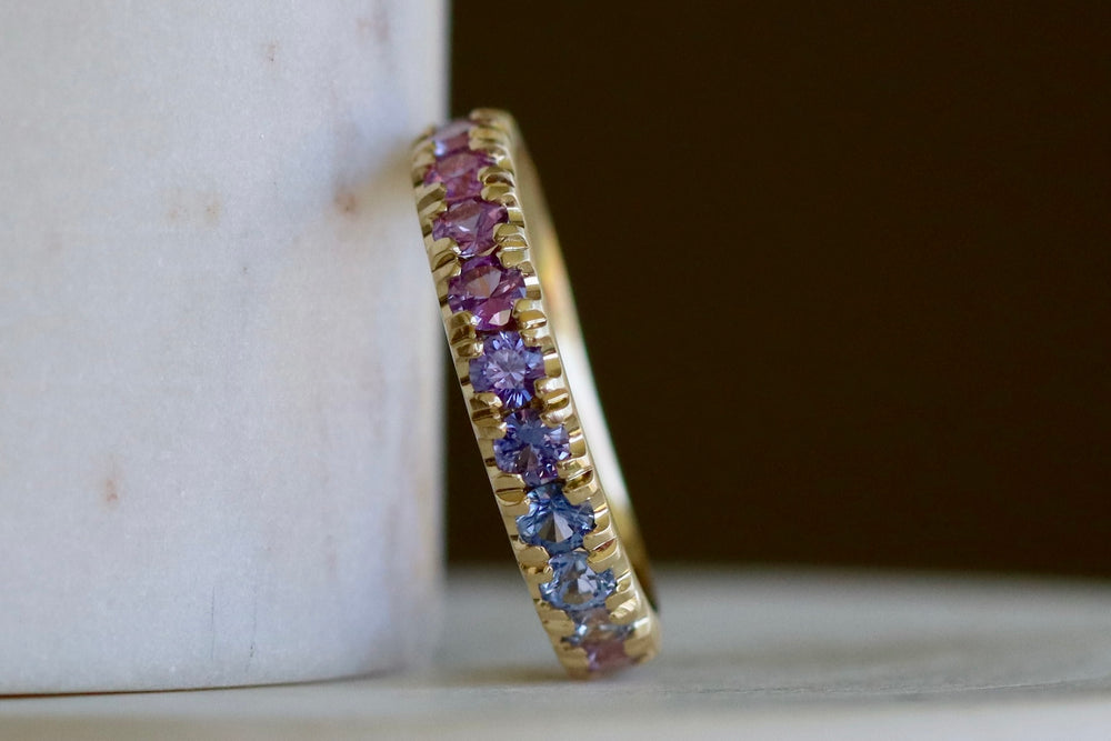 Front of Purple Ombre Sapphire Euro Band by Elizabeth Street Jewelry with rose cut sapphires in mid pink to purple and blue.