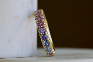 Front of Purple Ombre Sapphire Euro Band by Elizabeth Street Jewelry with rose cut sapphires in mid pink to purple and blue.