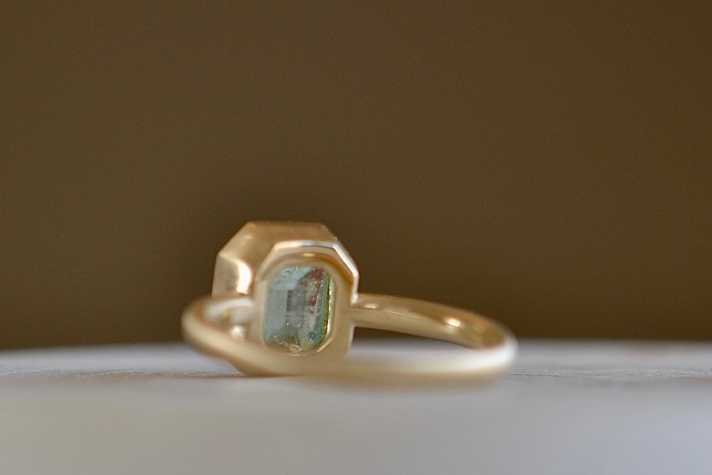 Alternate view of the simple Emerald Rectangular ring by Elizabeth Street made with a pale Columbian emerald.
