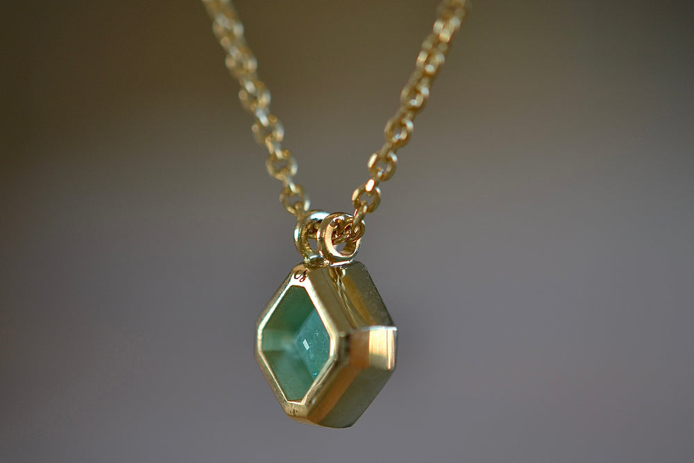 Side view of the Duo bale offset Emerald necklace by Elizabeth Street Jewelry. 