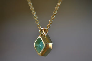 Side view of the Duo bale offset Emerald necklace by Elizabeth Street Jewelry. 