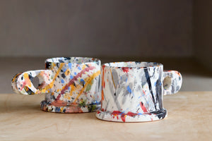 Black red blue orange with blue drip and Black, red, Blue and orange EXP splatter mugs available at OK the store in Los Angeles.