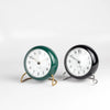 Classic Arne Jacobsen "AJ" Alarm Clock in green and black on white background.  AA batteries not included. 