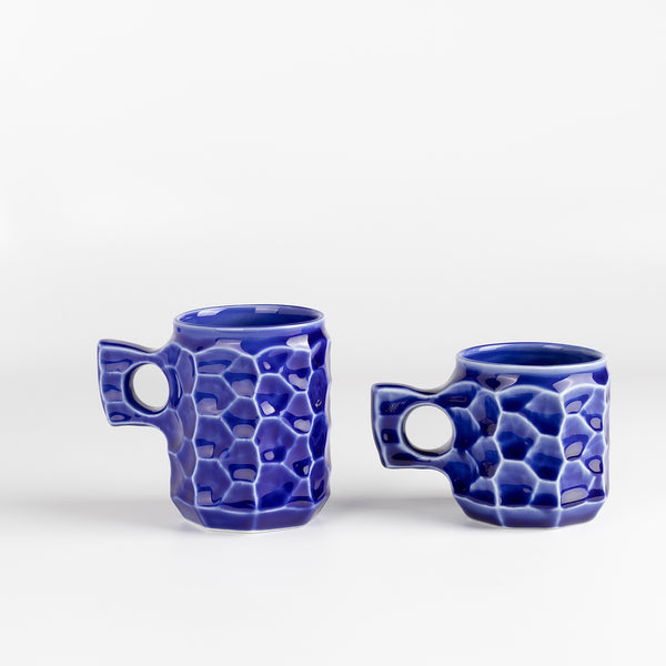 Large and medium Cobalt Blue Ceramic Jin cups from Akihiro Woodworks is a collaboration with One Kiln Ceramics utilizing porcelain mud casting and local wood ash in the glaze to achieve the color. Each mug is slightly different from another. Made by Akihiro Woodworks in Kagoshima, Japan.
