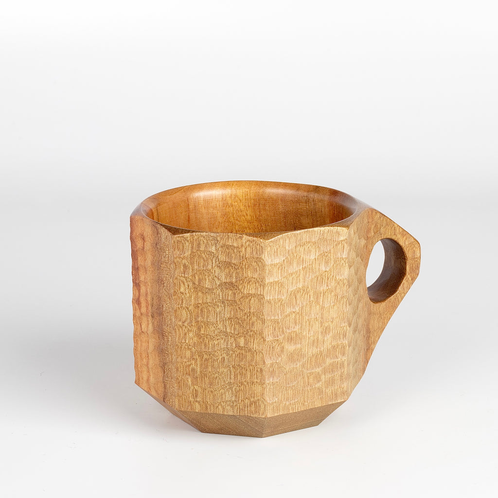 Close up of hand carved tabunoki wood Mother Jin Cup sold as set with book.