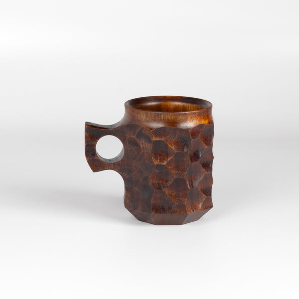 Jincup Urushi Large from Akihiro Woodworks is carved out of Tabunki wood. It takes five years to dry and can only be made in limited quantities to remain sustainable. This mug is made with Fuki-urushi lacquer, also called suri-urushi, a traditional and durable finishing technique where raw, liquid lacquer (tree sap), is rubbed into the wood grain with a cotton cloth and then wiped off, repeating the process multiple times to enhance the natural wood texture while providing a protective (us