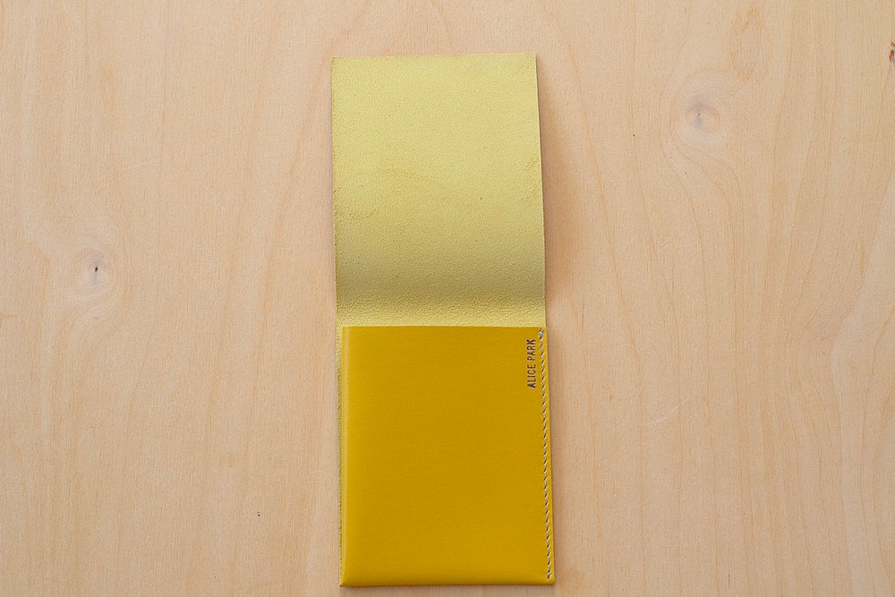 Alice Park Flap Wallet in yellow with white stitching.