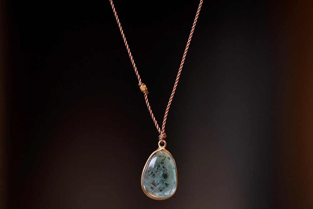 Unusual Emerald Pendant Necklace with Inclusions by Margaret Solow set in 14k gold.