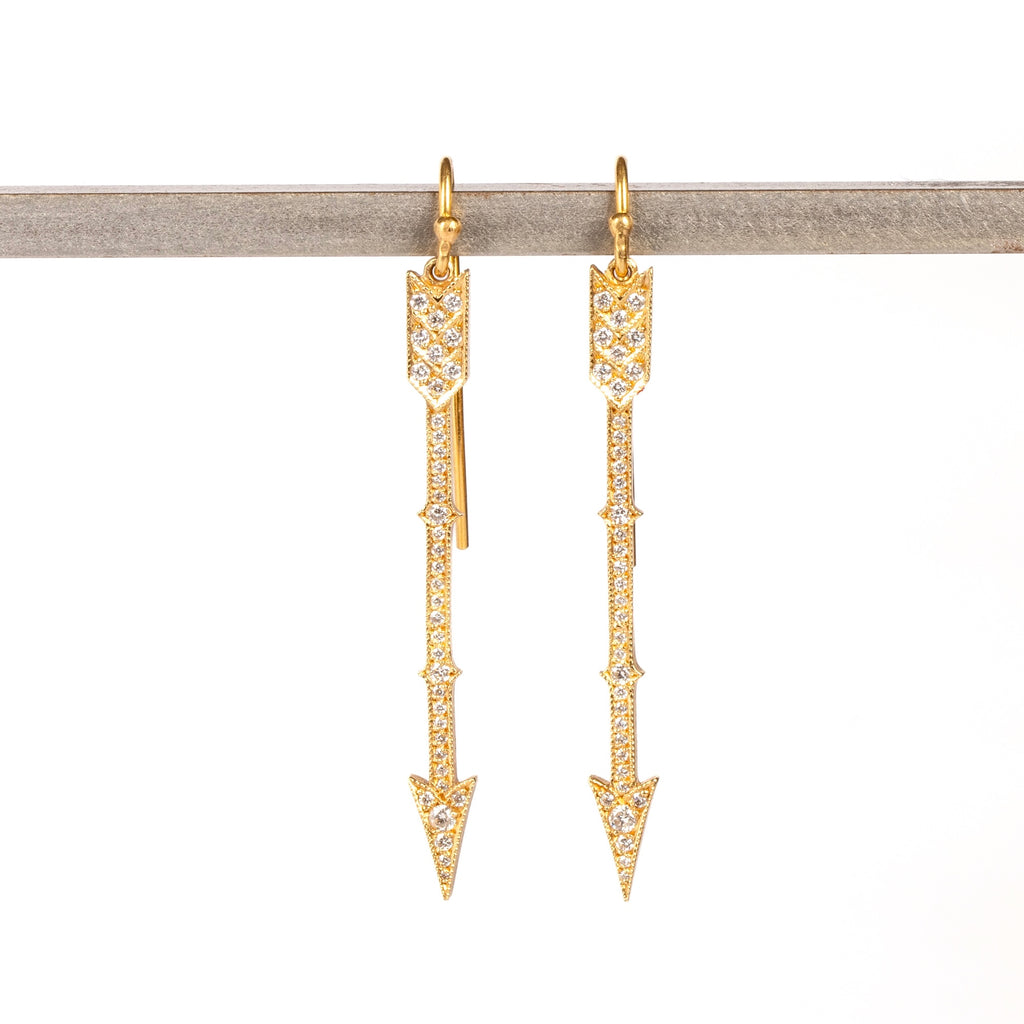 Arrow drop earrings in 18k with diamonds by Arman Sarkisyan are 45mm long arrowns in gold with white round cut diamonds on french hooks.