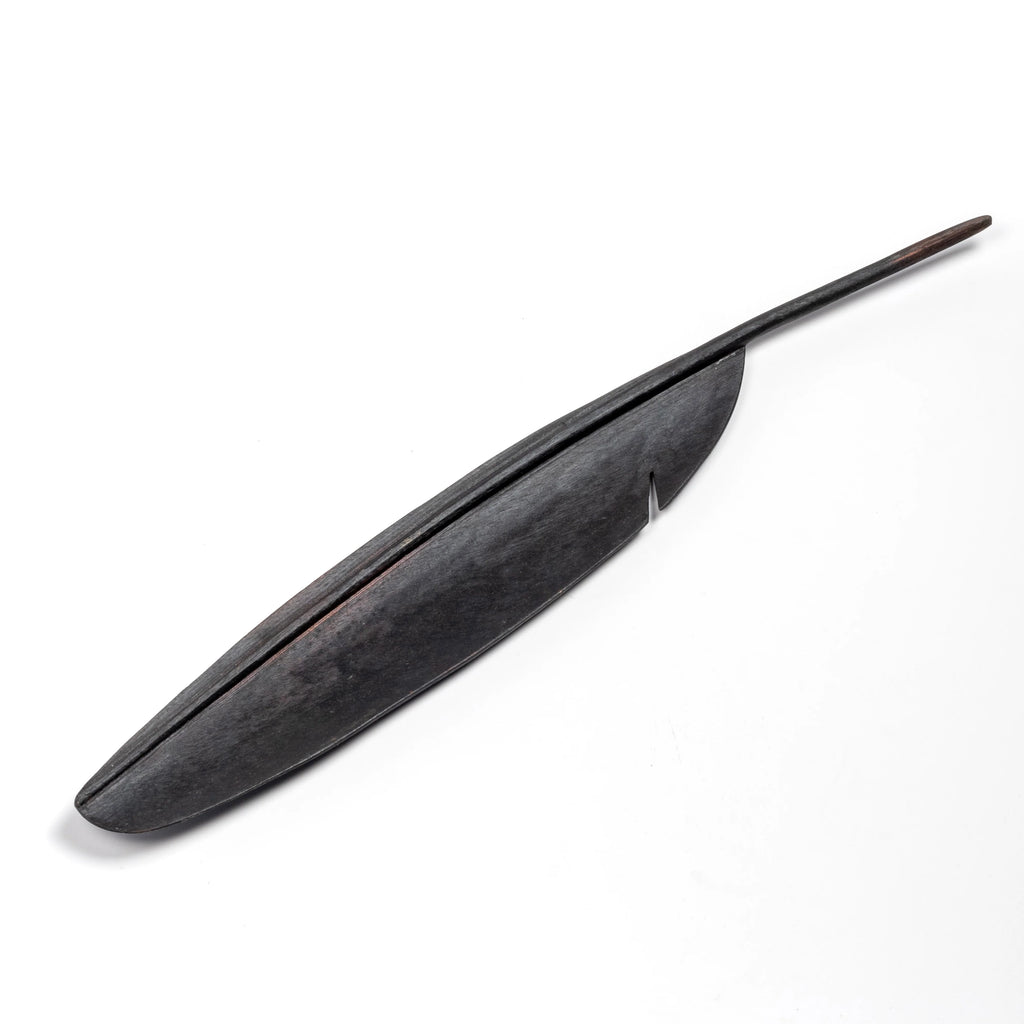 A sculpture of a feather to double as a fountain pen rest 3650 in patina.  Designed by Carl Auböck and handmade in Austria. Founded in 1906, the workshop is still owned and operated by the Auböck family. 