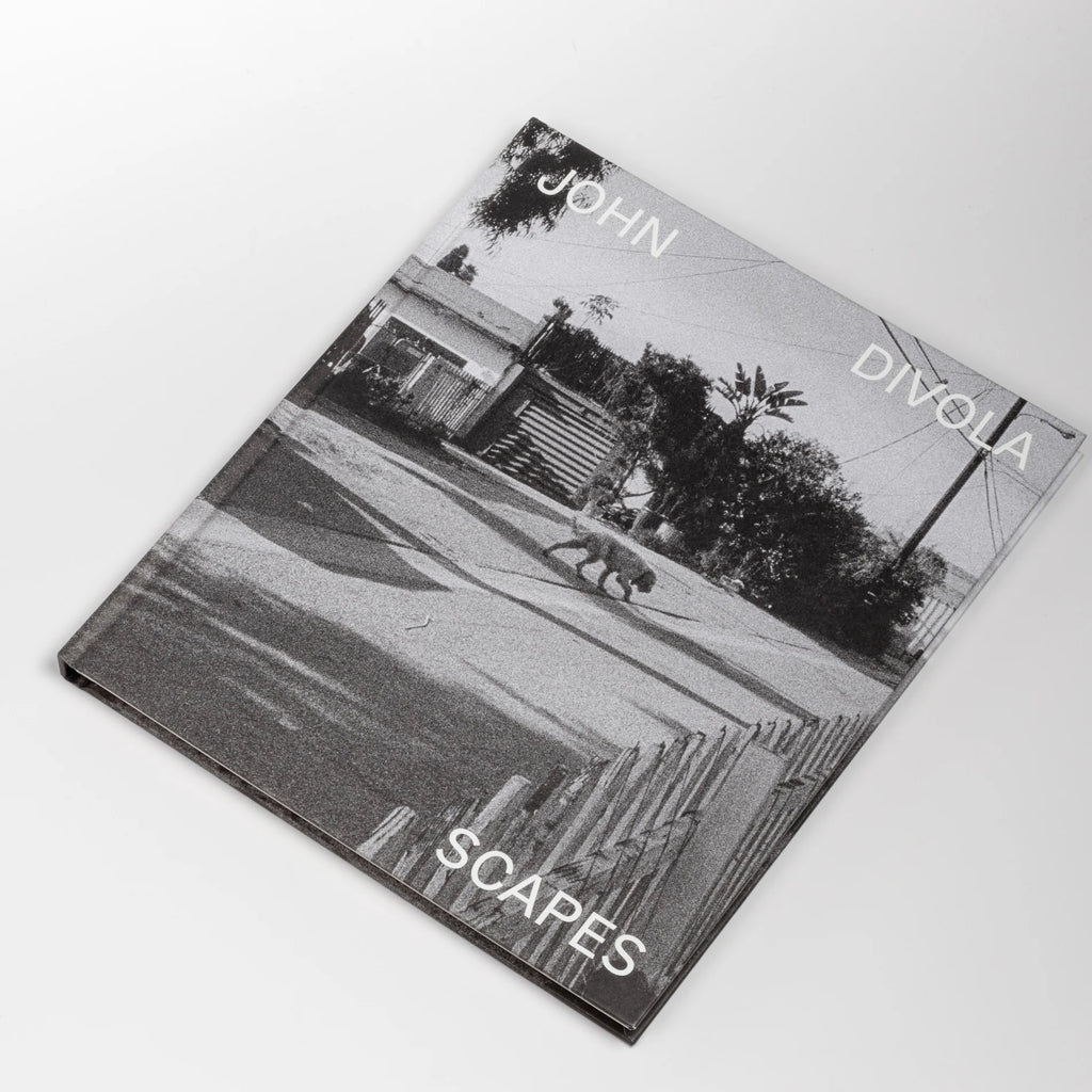 Scapes by John Diviola is a book From visual artist John Diviola comes this book of black and white photographs including&nbsp; "Four Landscapes," "As Far I Could Get," and&nbsp; "Dogs Chasing My Car in the Desert". Text by David Campany..&nbsp; Published by SkinnerBoox in an edition of 750. Rare and out of print.