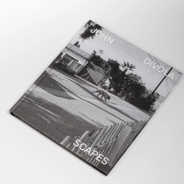 Scapes by John Diviola is a book From visual artist John Diviola comes this book of black and white photographs including&nbsp; "Four Landscapes," "As Far I Could Get," and&nbsp; "Dogs Chasing My Car in the Desert". Text by David Campany..&nbsp; Published by SkinnerBoox in an edition of 750. Rare and out of print.