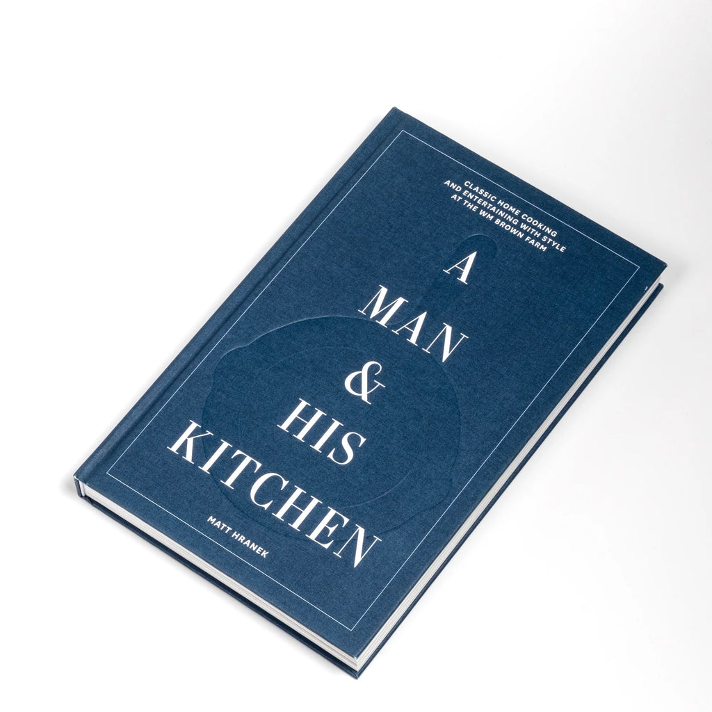 A Man and His Kitchen cookbook by Matt Hranek on white background. This is a great book for anyone who wants to learn how to cook real food.