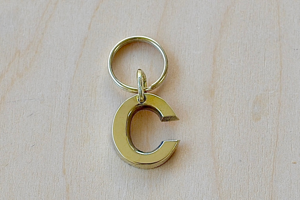 'C' Letter keyring, key chain, key ring in brass made by Carl Aubock. 