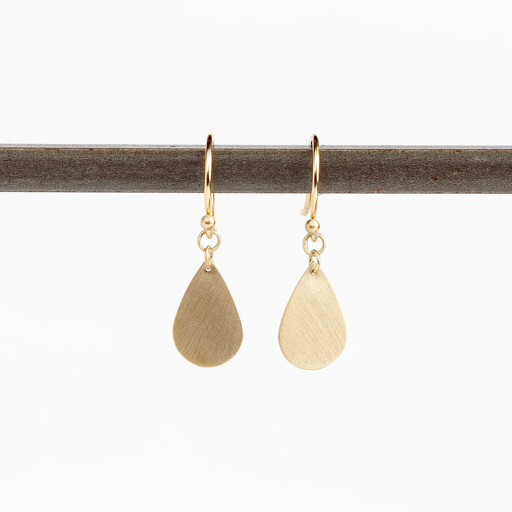 Pair of Teardrop Earrings by Carla Caruso. A single gold and flat teardrop hangs from an ear wire in 14k satin gold, allowing for lots of movement. Handmade in Massachusetts.