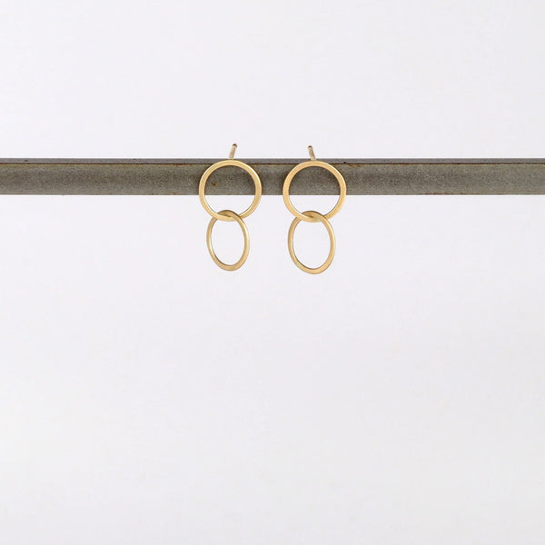 Double Circle Stud Earrings in matte 14k yellow gold designed and handmade by Carla Caruso on white background.