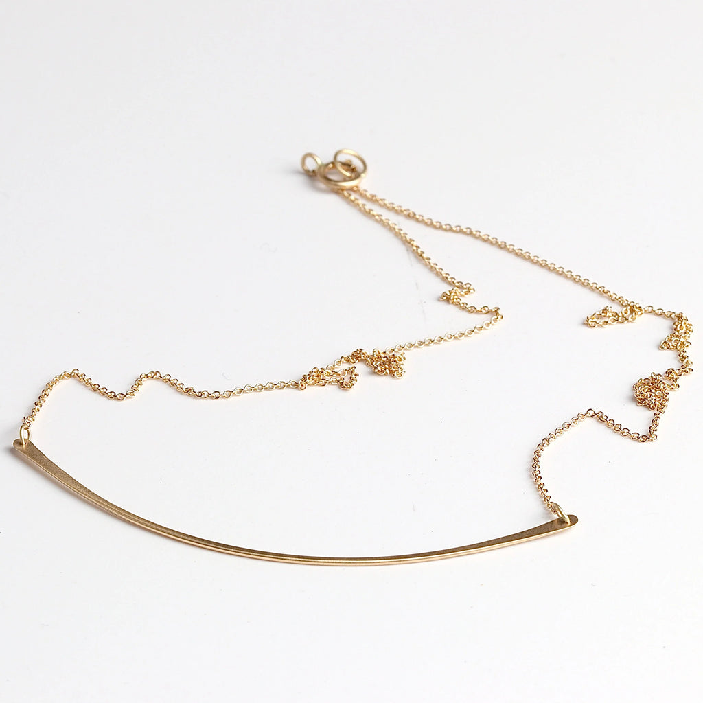 Horizontal fringe necklace on white background.