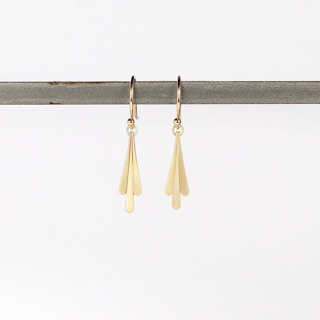 Carla Caruso Triple Fringe Drop earrings on whitr background in 14k yellow satin matte gold. Everyday Elegance.