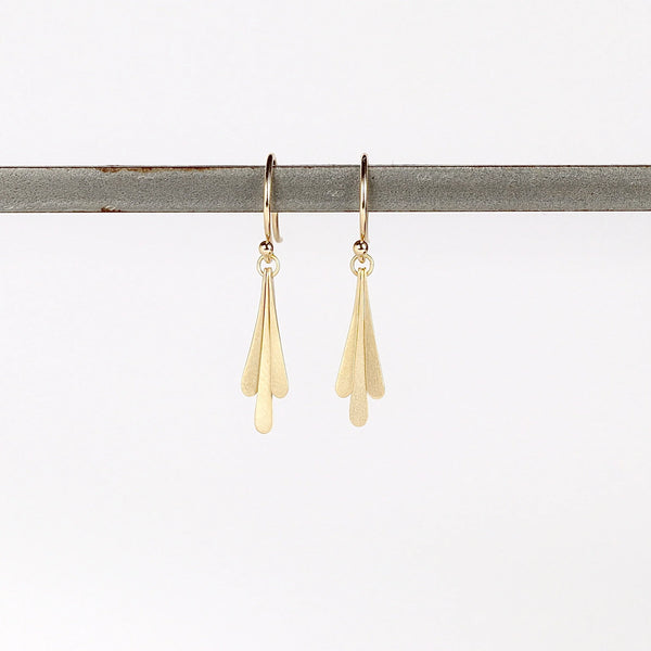 Carla Caruso Triple Fringe Drop earrings on whitr background in 14k yellow satin matte gold. Everyday Elegance.