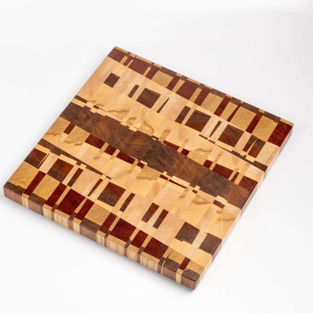 Medium Cutting Board by Chris Karlson Design is a Chock-A-Block Cutting Board made with end grain hard woods and is as good as a chopping block as it is a serving board.