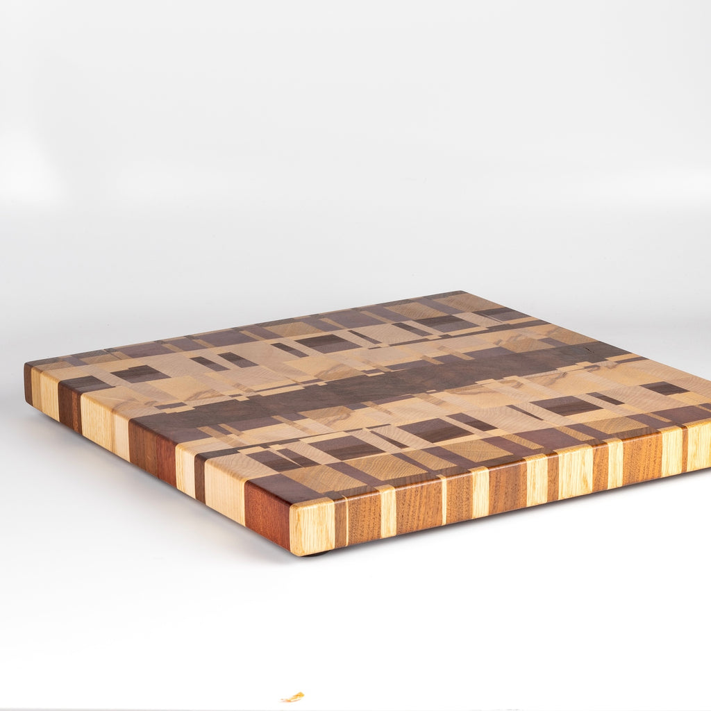 Cutting board, butcher's block and display board all in one, made by Chris Karlson in mixed hardwoods includig cherry.