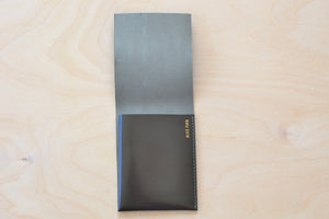 Inside of Dark Brown Alice Park simple flap wallet with olive stitching.