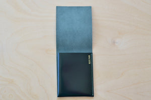Inside of Dark Green Alice Park simple flap wallet with green stitching.