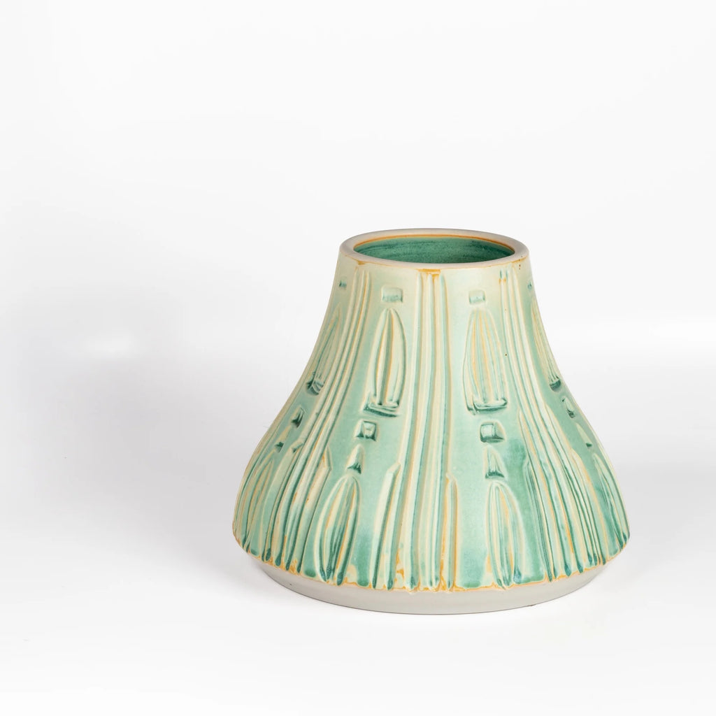 Irving Place Carved Ceramic Vase in Turquoise is a one of a kind Irving Place Studio (IPS) vessel made and signed by Dora De Larios (1933-2018) in 2015 on white background.