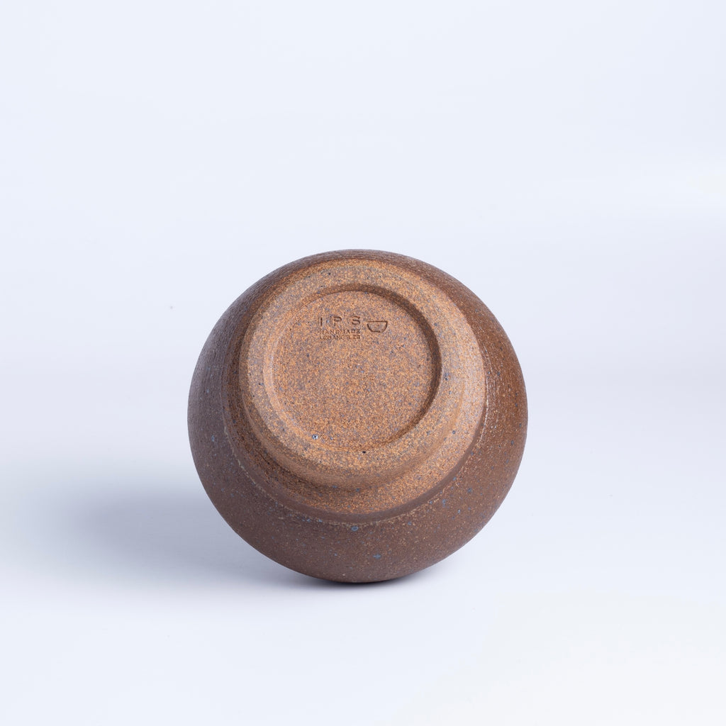 Showing stamp on brown bottle shaped vase by Irving Place Studio (IPS).