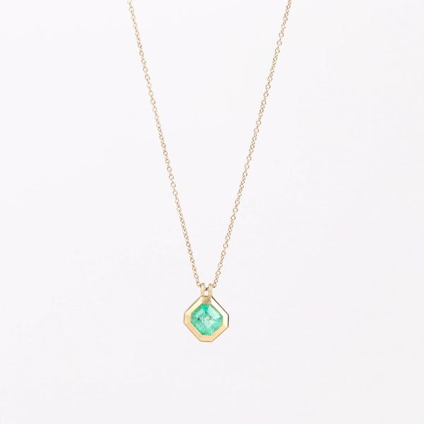 Duo Bale Offset Emerald Necklace by Elizabeth Street Jewelry is a  bezel set, translucent and offset square Colombian emerald with twin bales and on a 14k yellow gold chain. Perfect for layering or to wear as a solo piece. 