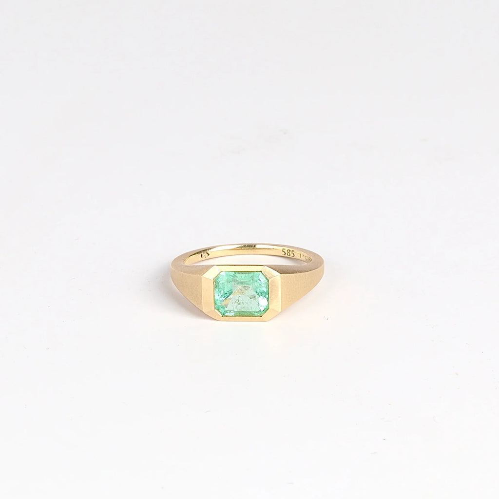 Emerald Signet ring by Elizabeth Street Jewelry is a one of a kind lightly faceted Colombian emerald on a tapered band with squared edges in 14k satin finish yellow gold.