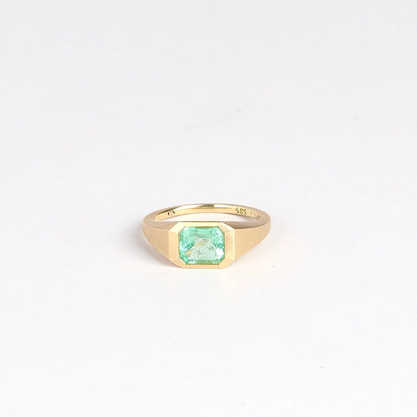 Emerald Signet ring by Elizabeth Street Jewelry is a one of a kind lightly faceted Colombian emerald on a tapered band with squared edges in 14k satin finish yellow gold.