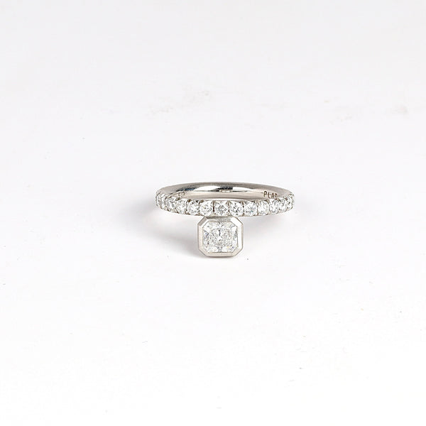 Offset Floating Solitaire by Elizabeth Street Jewelry is an offset center radiant cut white diamond (IVS1) .76ct on a 3/4 eternity band of white diamonds in platinum.