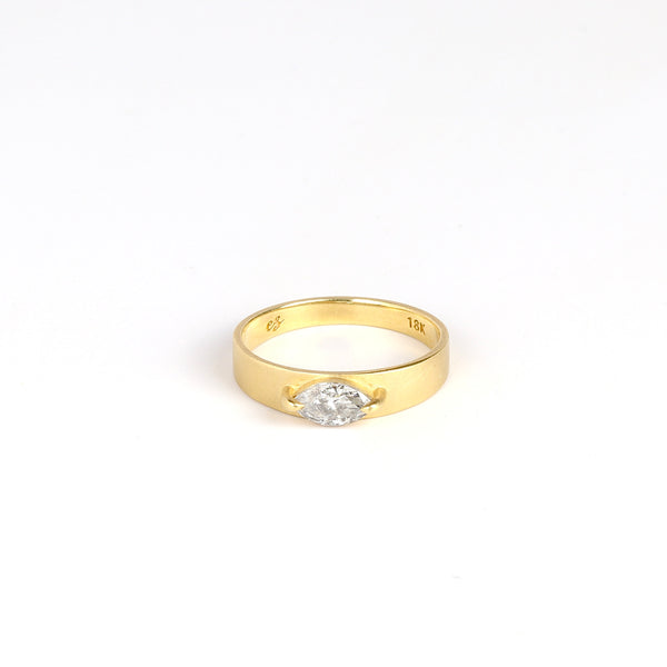 lim Cigar Band with Diamond by Elizabeth Street Jewelry on white background.This is a band with slight taper and a marquise cut salt and pepper diamond in a two prong eagle claw bezel setting, using 14k gold. Handmade in Los Angeles. Size 6.5 in stock.