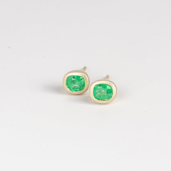 Bezel set Emerald stud earrings by Elizabeth Street Jewelry, a pair of heavy bezel Colombian emerald (.69TCW) studs with post closure in 14k yellow gold. Handmade in Los Angeles.